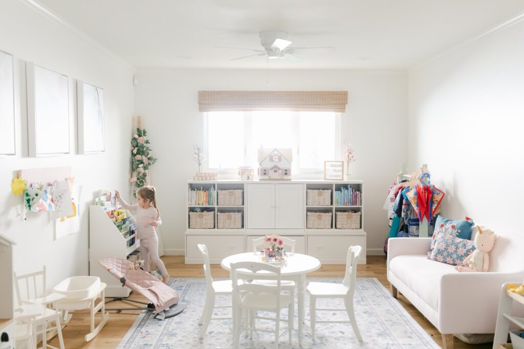 Child organizing books in a bright, professionally organized playroom in Phoenix, AZ